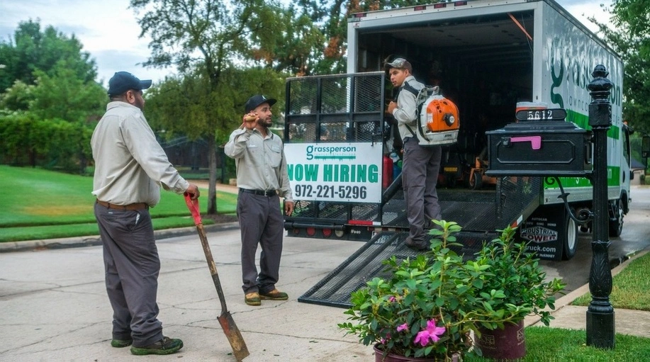 Professional landscaping team with service vehicle